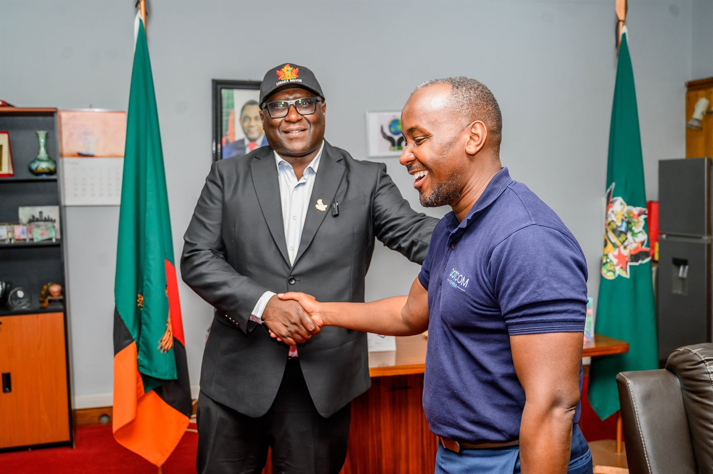 Lusaka Mayor Chitambala Mwewa shaking hands with Dot Com Zambia Managing Director Mawano Kambeu